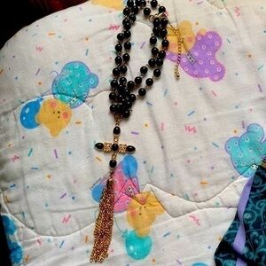 Black Rosary Beads with black & gold cross, yellow gold tassels. Lobster closes